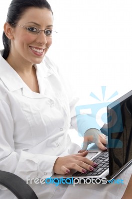 Smiling Doctor Working On Laptop Stock Photo