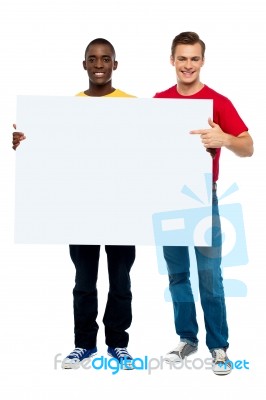 Smiling Guys Pointing White Board Stock Photo