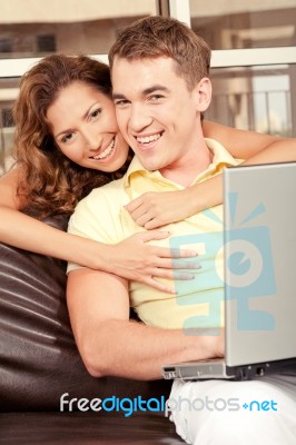 Smiling Love Couple With Laptop Stock Photo