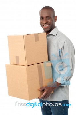 Smiling Man Holding Cardboard Boxes Stock Photo