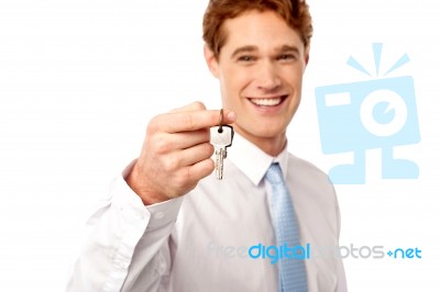 Smiling Man Offering House Key Stock Photo