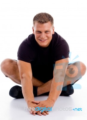 Smiling man sitting in floor Stock Photo