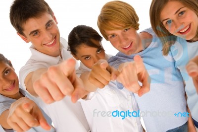 Smiling Teenagers Pointing Upward Stock Photo