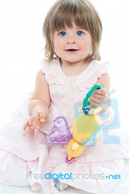 Smiling Toddler Holding Rattle Stock Photo