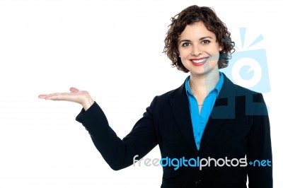 Smiling Woman Posing With Open Palm Stock Photo