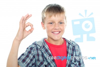 Smiling young boy showing ok sign Stock Photo