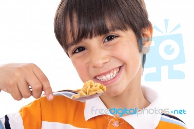 Smiling Young Boy With Spoon Of Flakes, Closeup Stock Photo