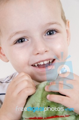 Smiling young child holding toy Stock Photo
