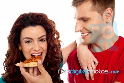 Smiling Young Couple Eating Pizza Stock Photo