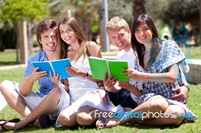 Smiling Young Couple Holding Books Posing To Camera Stock Photo