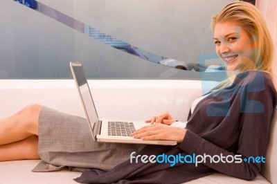 Smiling Young Woman Using Laptop Sitting Couch Stock Photo