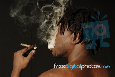 Smoking African Man Stock Photo