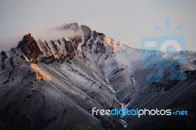 Snow Covered Mountain Peak In Alaska Stock Photo