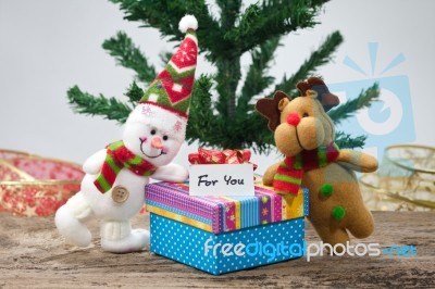 Snowman With Christmas Gift Stock Photo