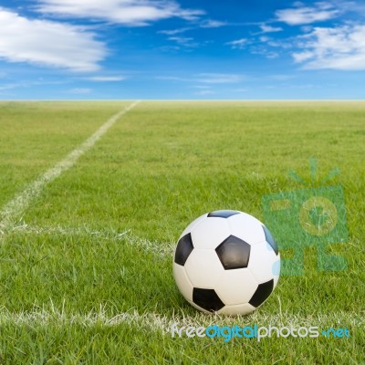 Soccer Ball On Soccer Field Against Blue Sky Stock Photo