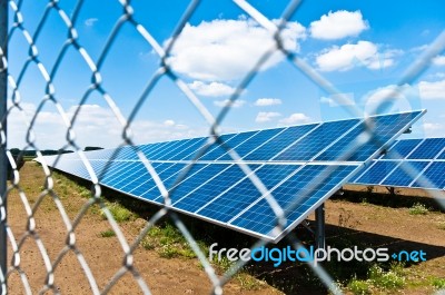 Solar Panels Behind Fence Stock Photo