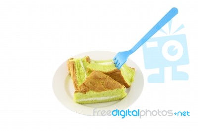 Sponge Cream Cake Dish And Fork On White Background Stock Photo
