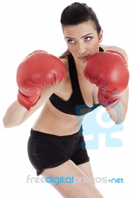 Sporty Girl In Boxing Gloves Punching Stock Photo