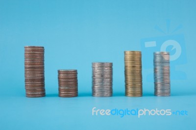 Stack Of Coins On Blue Soft Background Stock Photo