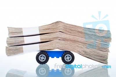 Stacks Of Banknotes On Toy Car Wheels Stock Photo