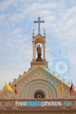 Statue Of Priest On The Gable Top Of Roof Church Stock Photo