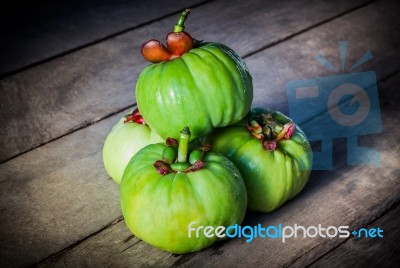 Still Life With Fresh Garcinia Cambogia On Wooden Background (thai Herb) Stock Photo