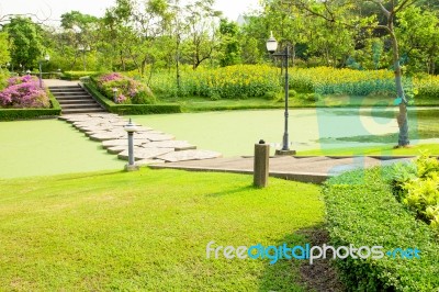 Stone Walkway Across Water In The Park Stock Photo