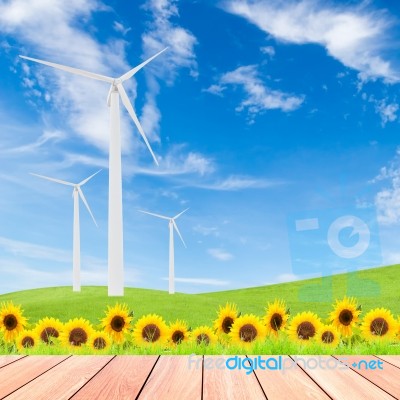 Sunflowers With Wind Turbine On Green Grass Field Against Blue S… Stock Photo