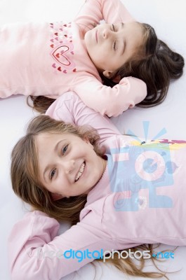 Sweet Little Laying Sisters Stock Photo