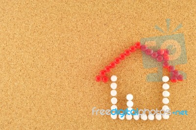Symbol Of Home Pinned On Cork Board Stock Photo