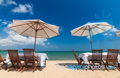 Table Set And Umbrella On The Beach Stock Photo - Royalty Free Image ID