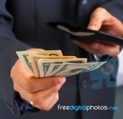 Taking Money From Wallet Stock Photo