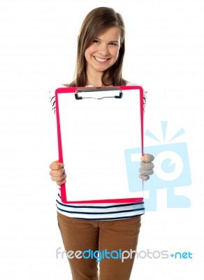 Teen Showing Paper On Clipboard Stock Photo