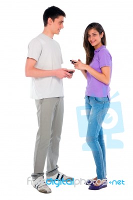 Teenage Couple Holding Smartphone Stock Photo