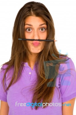Teenage Girl Balancing Pencil Stock Photo