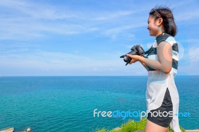Teenage Girl Is Holding Camera On High Stock Photo