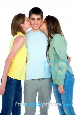 Teenage Girls Kissing Boy Stock Photo