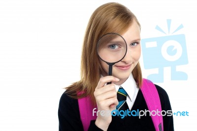 Teenager Looking Through A Magnifying Glass Stock Photo