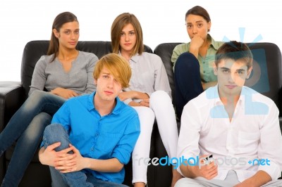 Teenagers holding TV remote Stock Photo