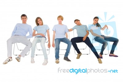 Teenagers Sitting On Chairs Stock Photo