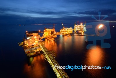 The  Large Offshore Oil Rig Drilling Platform At Night Stock Photo