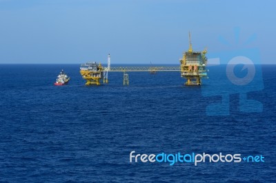 The Offshore Oil Rig And Supply Boat Stock Photo