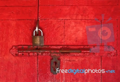 The Old Master Key And Old Bolt On Red Wooden Door Stock Photo