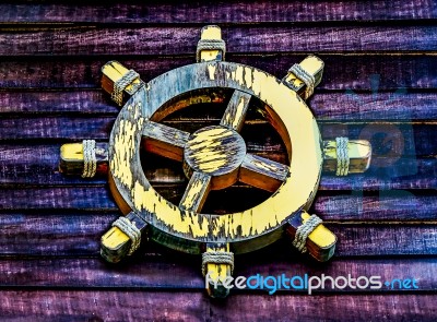 The Old Wooden Ship Wheel Stock Photo