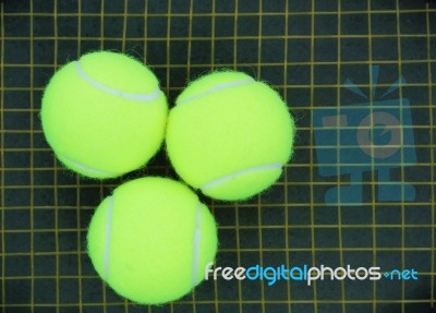 Three Tennis Balls On A Racket Stock Photo