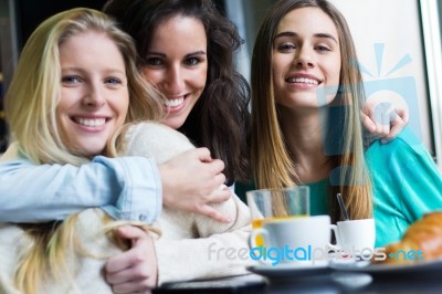 Three Young Women Having Coffee Break Stock Photo