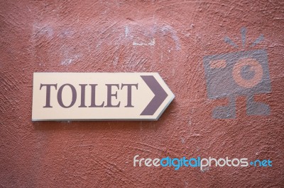 Toilet Sign On The Old Wall Stock Photo