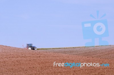 Tractor Plowing On Field Stock Photo