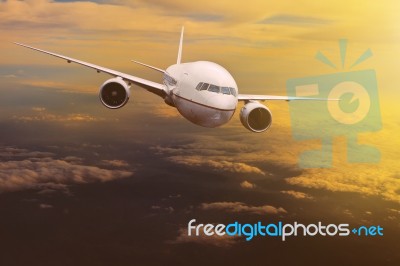 Traveling Plane Flying Over  Sun Rising Sky Stock Photo