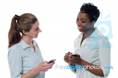 Two Corporate Women Having A Discussion Stock Photo